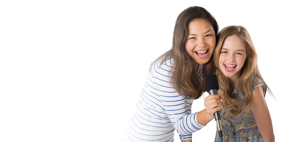 Two girls wearing Clarity Advanced Ceramic Braces by 3M Oral Care Solutions