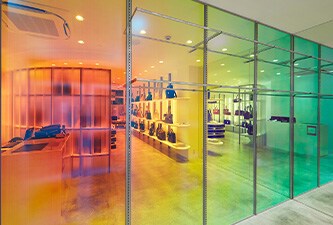 Schaufenster mit 3M Dichroic Glasdesignfolien in den Farben Grün, Gelb, Orange und Rot. 
