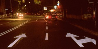 Autos, die im Dunkeln an einer Ampel warten
