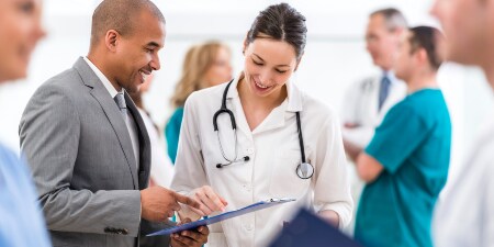 A doctor and a pacient are discussing something
