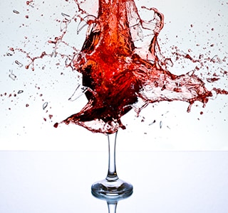 Red wine splashing into a wine glass