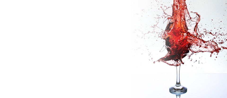 Red wine splashing into a wine glass