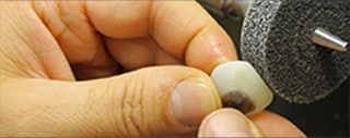 Image of worker grinding artificial eyeball.