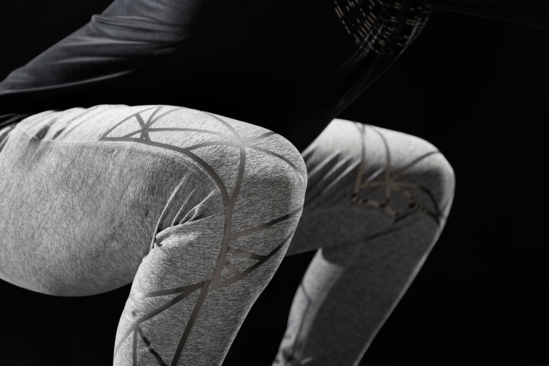 Mann macht Kniebeugen mit 3M Scotchlite Black Stretch Reflective, das sich über die Knie dehnt, nicht beleuchtet.