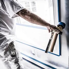 Professioneller Dekorateur bei der Vorbereitung einer Wand mit 3M Maler-Abdeckfolien