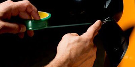 Ein Mann benutzt ein 3M™ Knifeless Tape
